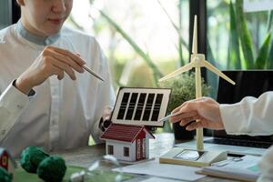 Eco-friendly Solutions and Green Technologies. A collaborative discussion on solar and wind energy integration. photo