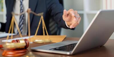 Law and Technology. A lawyer discussing strategies while pointing to a laptop. photo