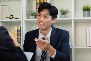 Client Relationships and Legal Strategy. A lawyer explaining points to a client. photo