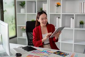 Creative Process and Digital Art. A graphic designer utilizing her tablet to explore new design concepts in a collaborative workspace. photo