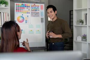 Team Collaboration and Creativity. A graphic design team brainstorming and discussing color palettes for a project. photo