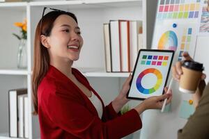 Creative Collaboration and Color Presentation. Team member showcases color options using digital tools to teammates. photo