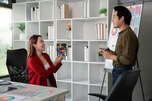 Graphic Design and Collaboration. Team members discussing color choices in a contemporary office setting. photo