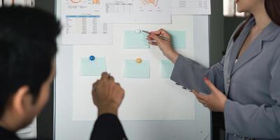 Data Analysis and Strategy. A focused discussion on performance metrics using visual aids during a team meeting. photo