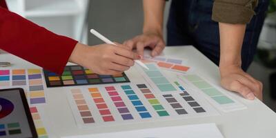 Hands-on Design and Collaboration. A designer collaborates with a colleague on color development for a project. photo
