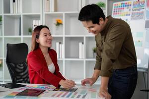 Color Selection and Teamwork. Colleagues collaborating on a visual design project in a professional setting. photo