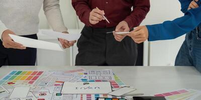 Idea Development and UX Strategies. Team exploring ideas for user experience strategies with sketches and digital tools. photo