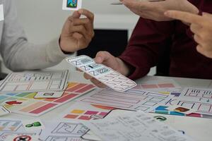 Team Collaboration in UI Design. Collaborators brainstorming and refining user interface sketches. photo