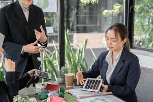 Sustainable Practices and Renewable Solutions. A professional evaluates solar technology in a strategic meeting. photo