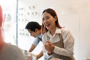 Welcoming Customer Experience. A barista showcasing enthusiasm while serving and interacting with customers in a bustling cafe. photo