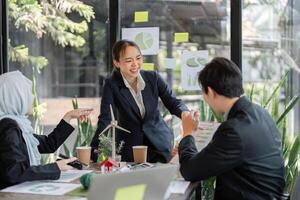 Sustainability and Team Collaboration. A professional team engages in a discussion about sustainable practices in an eco-friendly workspace. photo