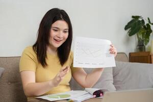 Remote Collaboration and Presentation. A woman shares a graph during a call to engage her audience. photo