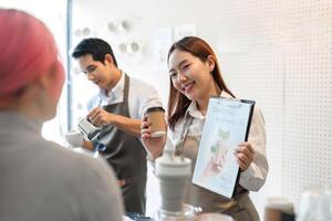 Sustainable Practices and Friendly Service. A barista showcases eco-friendly initiatives while serving coffee. photo