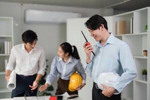 Effective Communication and Teamwork. Professionals discussing project details using communication devices in a collaborative environment. photo