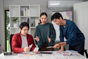 Innovative Design Solutions and Teamwork. A team evaluating UI concepts with enthusiasm in a collaborative space. photo