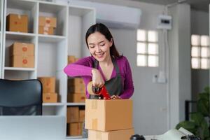 Efficient Order Preparation and Management. An engaged woman packaging products in her workspace, emphasizing the importance of streamlined processes in online sales. photo
