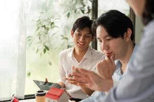 Client Interaction and Project Development. Young professionals engage in a collaborative discussion about design and project updates. photo