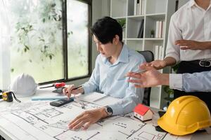 Design Development and Collaboration. An architect analyzing project designs while discussing with teammates in a modern office. photo