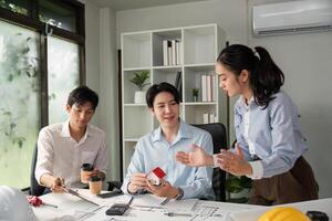 Professional Discussion and Project Review. A dynamic team evaluates construction models and project plans during a meeting. photo