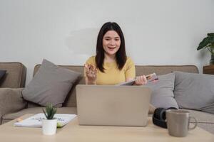 Remote Work and Virtual Communication. A young woman engaged in a call, demonstrating effective work-from-home techniques. photo