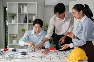 Collaborative Design Session and Planning. A team evaluates project details with models and blueprints on the table. photo