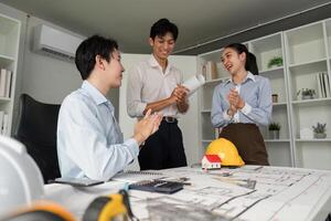 Project Completion and Team Spirit. A team celebrating their successful collaboration on a building design project. photo