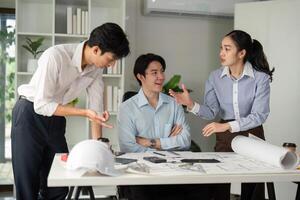 Team Dynamics and Idea Sharing. Professionals engaged in a lively discussion about building plans. photo