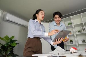 Digital Collaboration and Presentation. Team members sharing ideas using a tablet in a modern workspace. photo