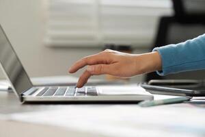 Focus and Productivity. A close-up of hands typing on a laptop, capturing the essence of creativity and concentration in the design field. photo