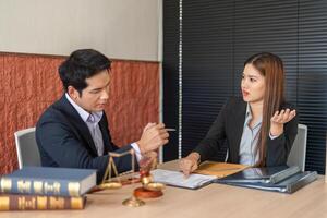 Legal Consultation and Client Interaction. Two lawyers engaged in a discussion about a case at the office, showcasing professional dynamics. photo