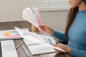 Color Consultation and Creation. A designer analyzing various color swatches to create an inspiring design. photo