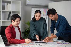 Team Dynamics and Design Collaboration. Team members reviewing color palettes and mockups for an innovative project. photo