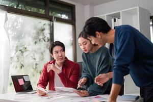 Brainstorming and UIUX Design. A creative team collaborates on user interface ideas and design concepts in a modern workspace. photo