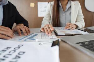 Strategic Meeting and Data Analysis. Professionals engaged in a financial discussion, utilizing data documentation for informed decision-making. photo