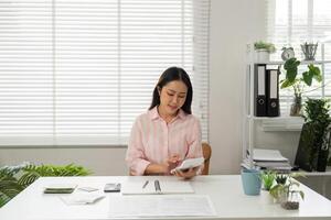 Home Office and Task Management. A person reviewing notes and planning projects in a serene and organized home workspace. photo