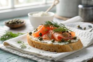 Delicious smoked salmon toast topped with capers and dill on a rustic table photo