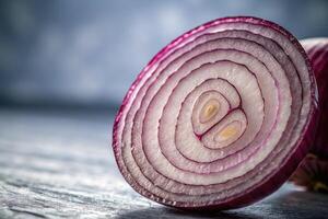 Sliced red onion displaying intricate layers and patterns on a wooden surface photo