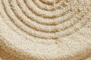 Smooth simple Lines on sand background, minimal aesthetic sandy texture. Spa, meditation, relaxation, wellness concept. Natural beige waves pattern in Japanese zen garden. View from above copy space photo