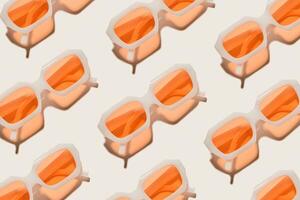 Stylish peach orange sunglasses on beige, minimal trend repeated pattern, sunlight shadow, summer fashion white transparent-framed glasses. Top view of rows of lying eyewear, beach concept photo