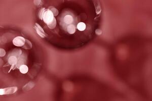 Wine glasses defocused, red wine color blurred background with light flare, optical blur, bokeh. Top view aesthetic still life photo alcoholic drinks art styles for winery, wine list