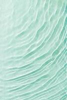Clear water and waves at sunlight, sun flare and bright white reflections on blue, turquoise water surface. Summer vivid gradient color, graphic nature, dynamic aquatic ripples pattern, aesthetic photo
