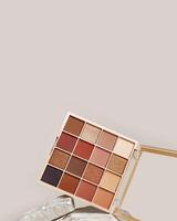 Eyeshadows palette mock up on stand from natural stone Beauty product cosmetic powder for make up eye, beige brown color scheme, matte and shimmer tints. Cosmetic product minimal style. photo