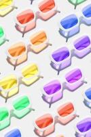 Minimal pattern from eyeglasses with rainbow colored glasses on white background, visual trends summer concept. Top view aesthetic photo, colored sunglasses as creative geometric pattern photo