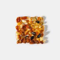 Natural gemstone amber stones with glare shadows, yellow orange colored on white background. Natural mineral Transparent amber gems, minimal flat lay pattern, creative top view, summer concept photo