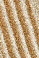 Aesthetic minimal natural sand background with sandy waves and ripples, light and shadows. Pastel colored zen garden fon for Spa, meditation, relaxation, wellness. Styled design photo, vertical photo