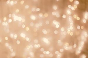 Defocused abstract bokeh background beige pastel colored, flare from lights, beige monochrome photo, blurred round bokeh as holiday fon, celebration wallpaper. Glittering aesthetic pattern photo