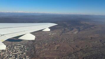 View from the airplane window of wing during sharp turn during takeoff. The plane lays down the flight path making sharp turn and tilting the body of the plane with view of the city video