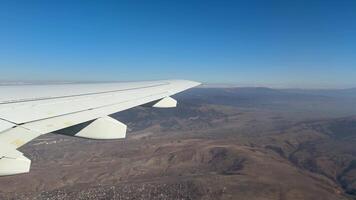 The best view from airplane window of wing during takeoff. Gaining altitude on plane with view of horizon with mountains. The best seats for plane flight with view of the wing of jet video