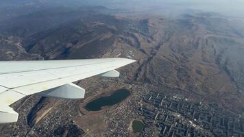 Airplane circles city during flight. Sharp turn with view from the window during sharp tilt of jet body. Airplane turns to enter the correct flight path. View from the airplane window during turn video