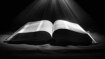 An open bible is shown in black and white photo